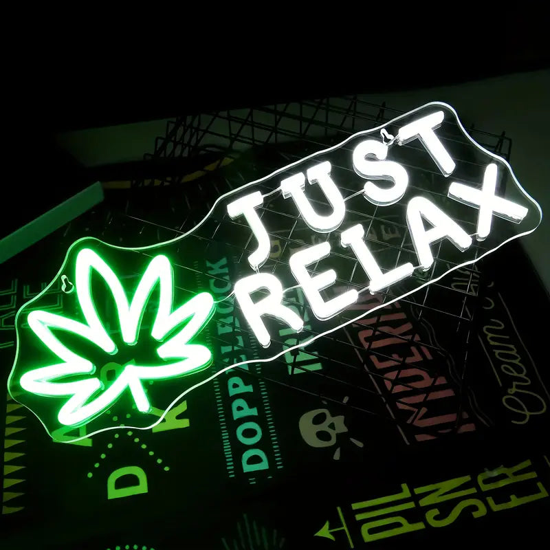 Green Just Relax neon sign with leaf design
