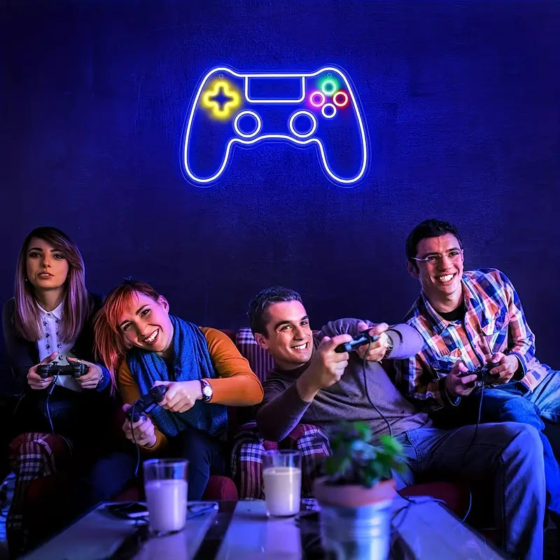 Friends gaming under a neon game controller sign
