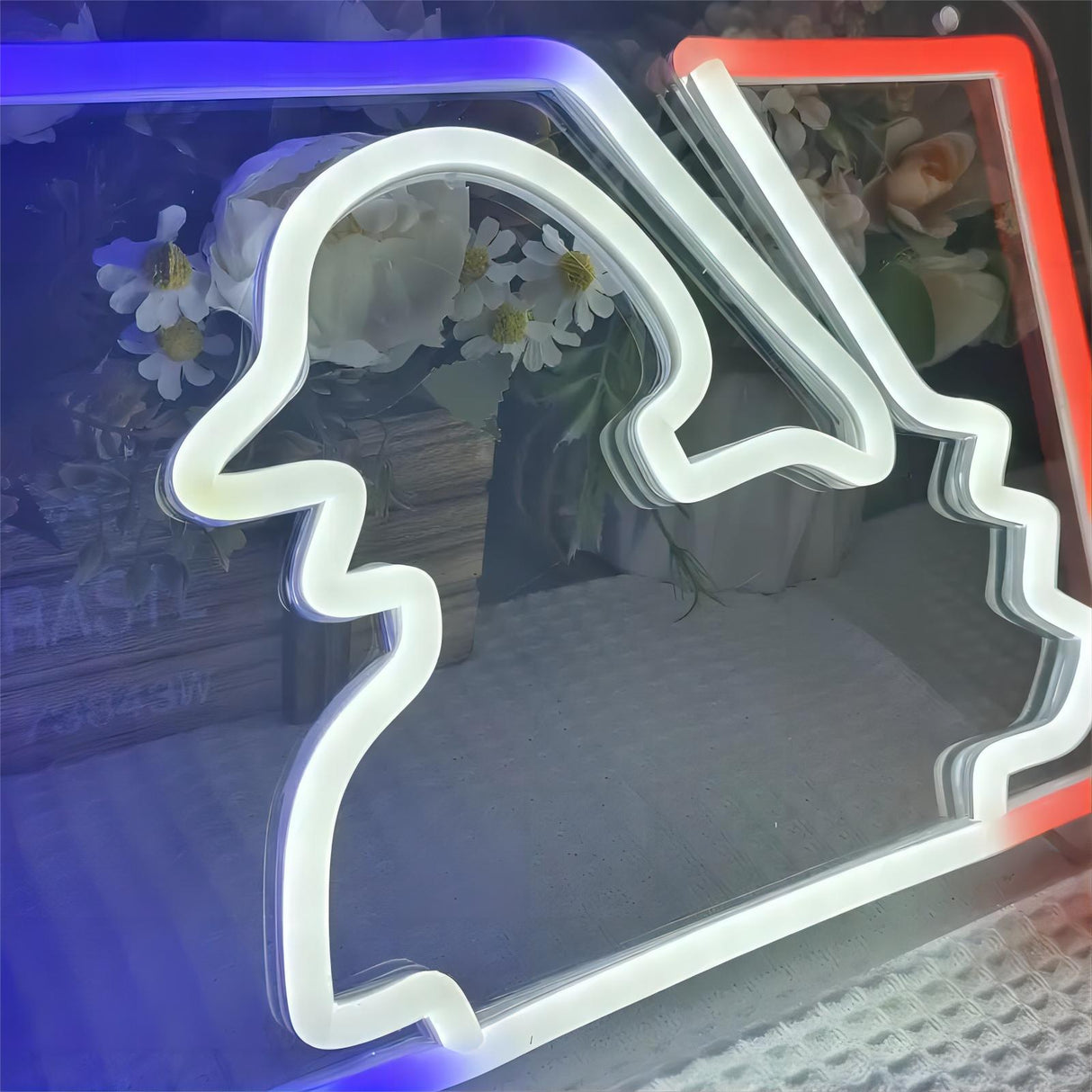 Baseball player neon sign, white neon outline with red and blue accents.