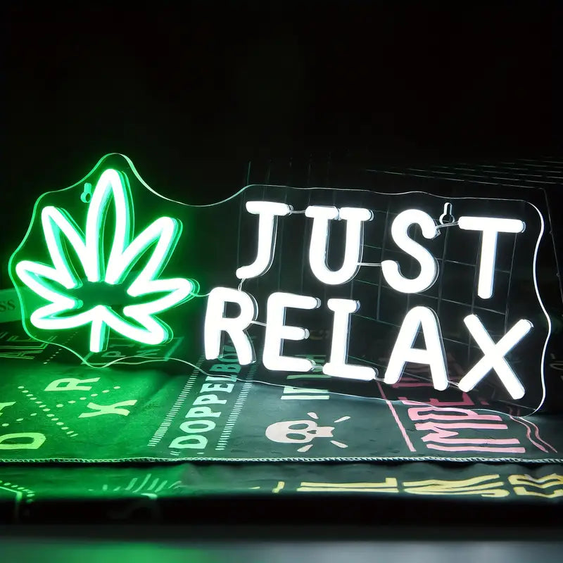 Green neon 'Just Relax' and leaf sign