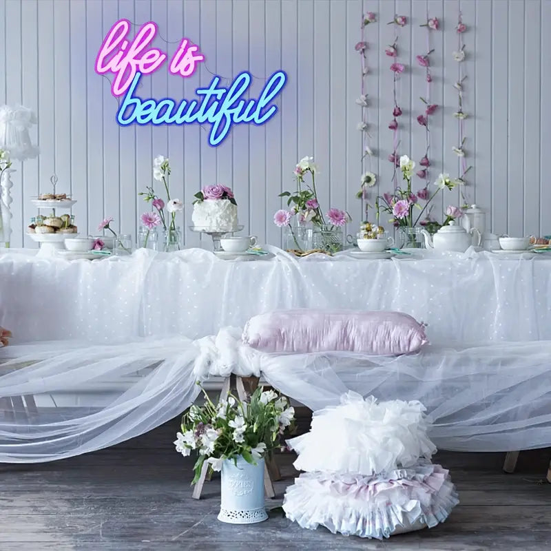 Life is Beautiful Neon Sign display at a party setting with decorations.