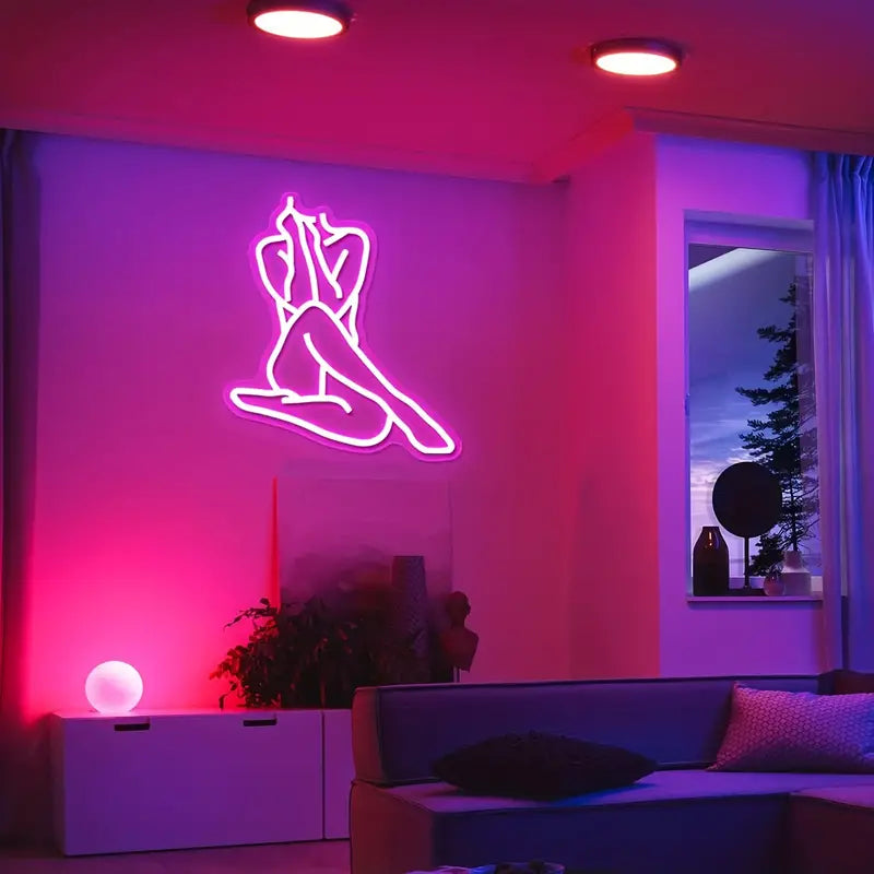 Pink neon light art of a woman in a modern room decor