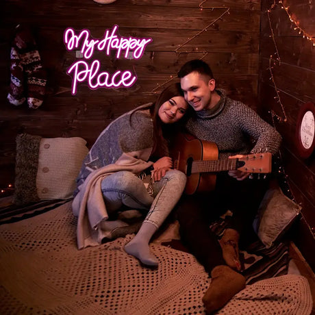 Couple relaxing with guitar under neon sign