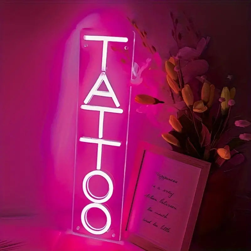 Pink neon TATTOO sign with decor