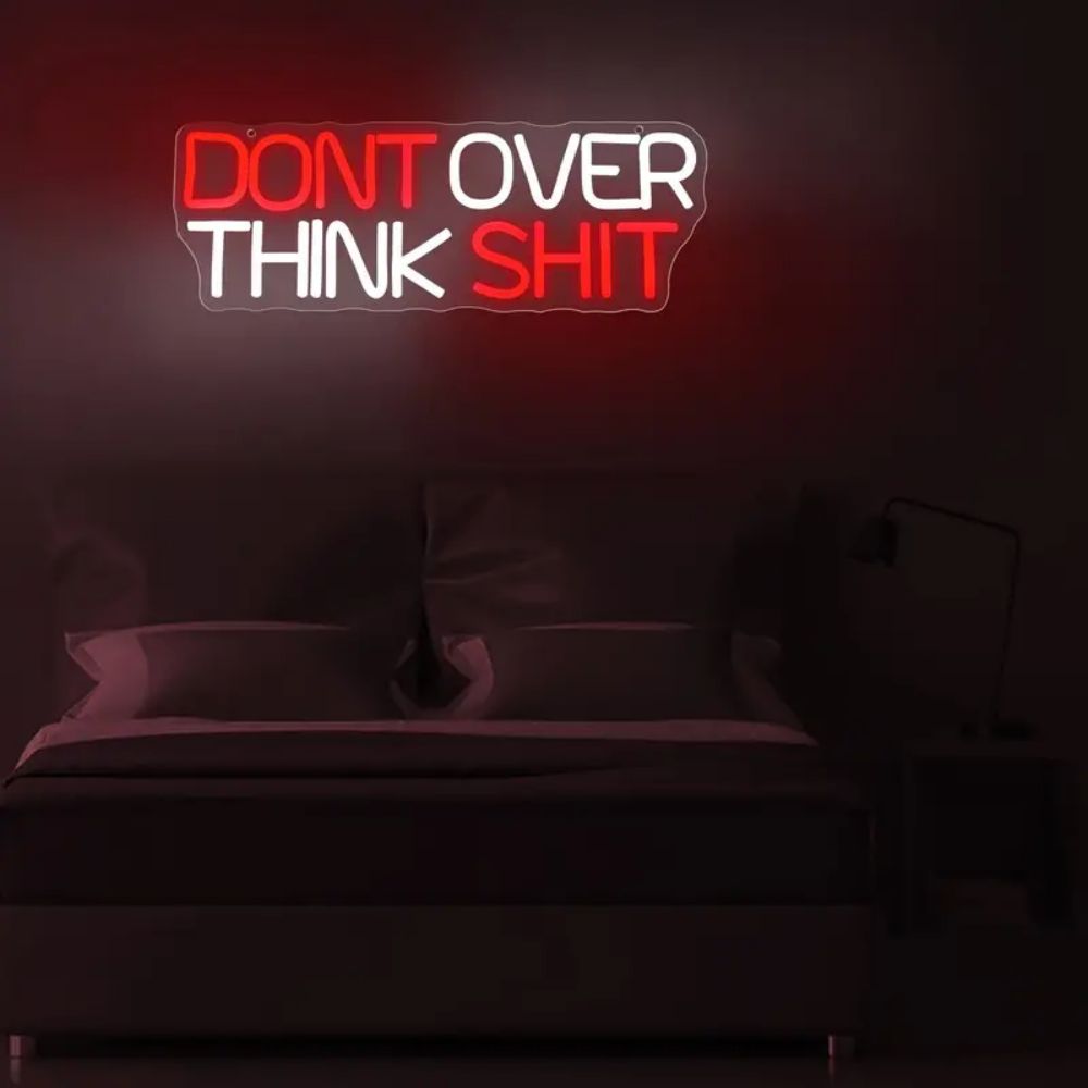 Don't Over Think Shit LED Neon Sign above a bed