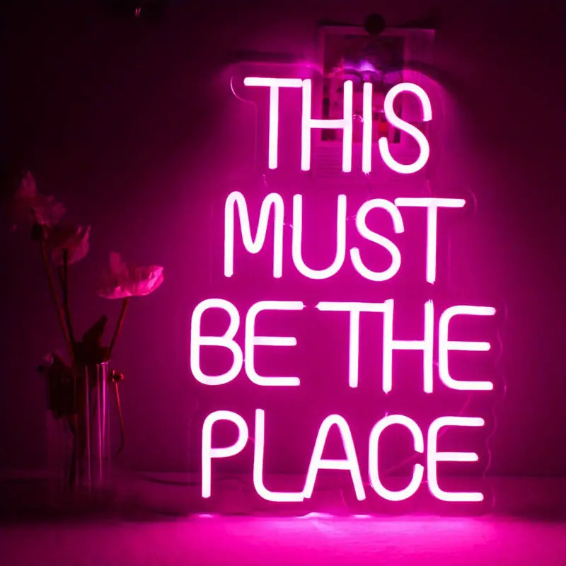 Pink neon sign: This Must Be The Place