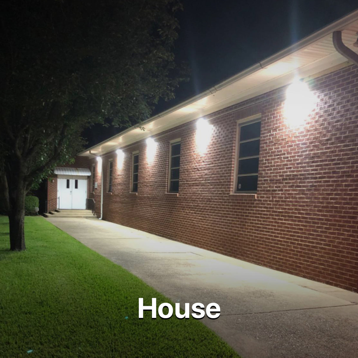 House exterior illuminated by wall pack lights