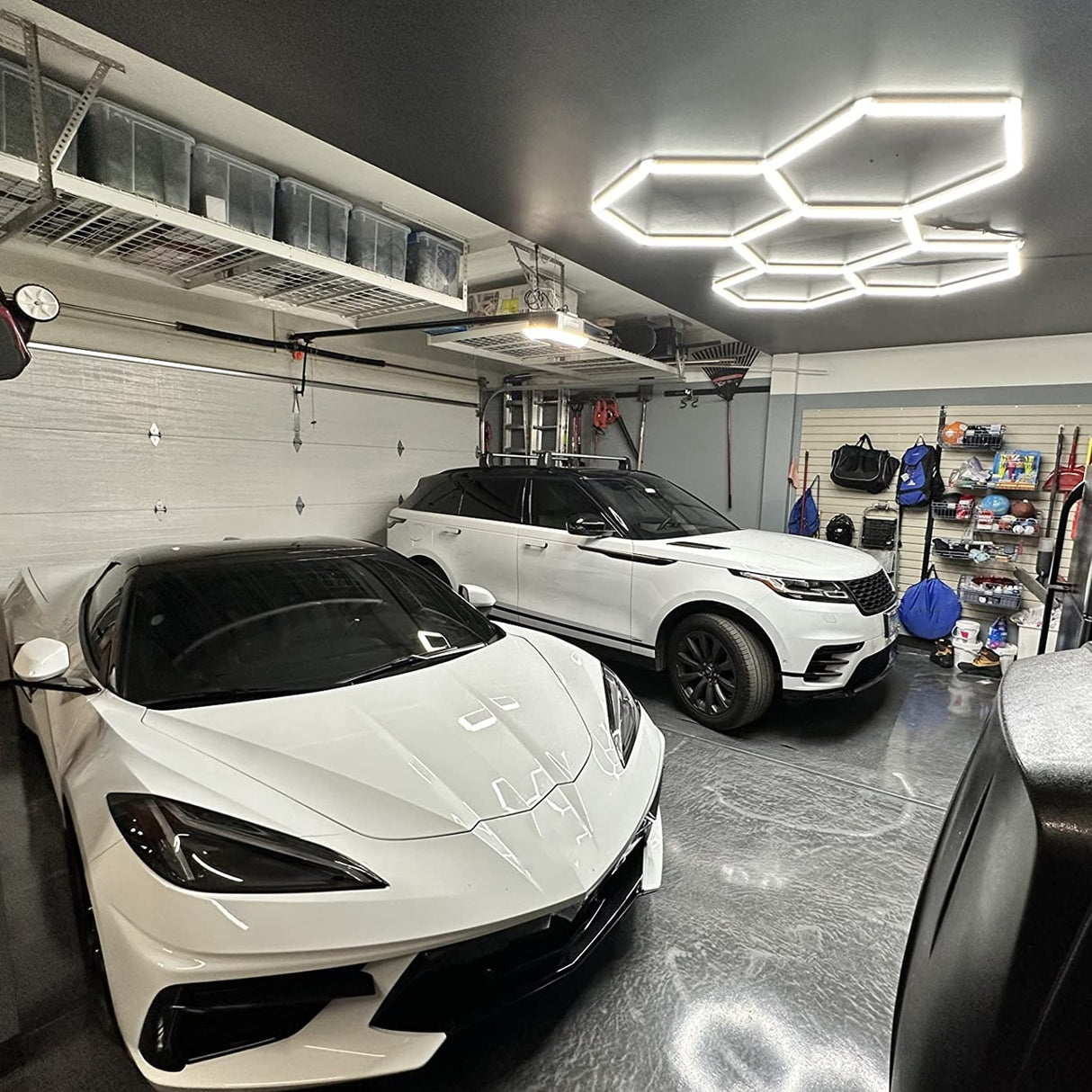 Modern garage with Hyperlite Hexagon lights and luxury cars