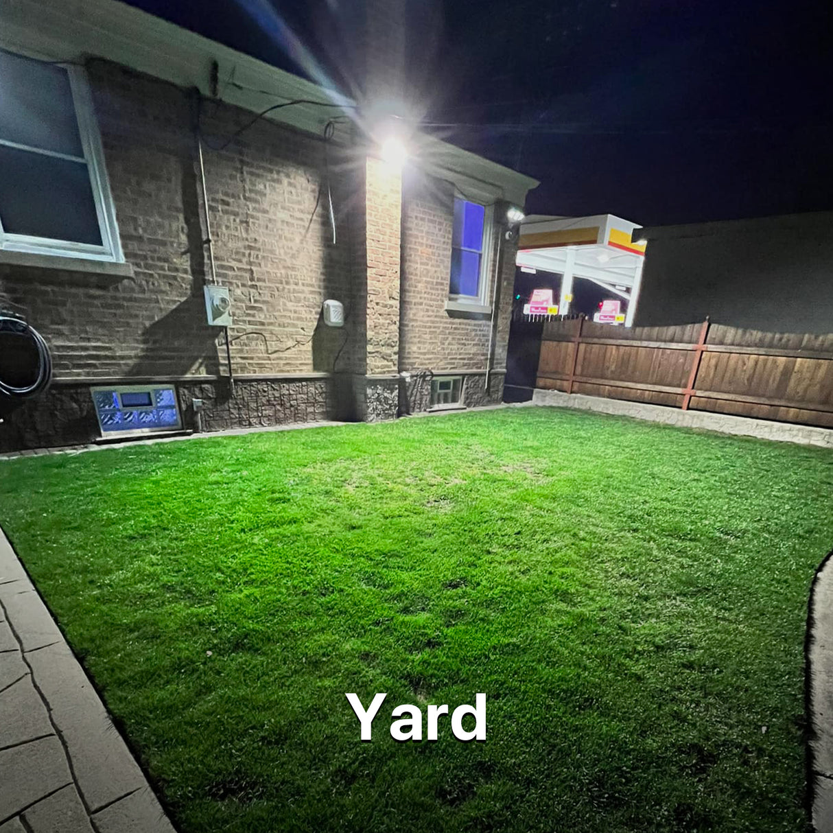 Yard illuminated by Hyperlite LED Wall Pack Light