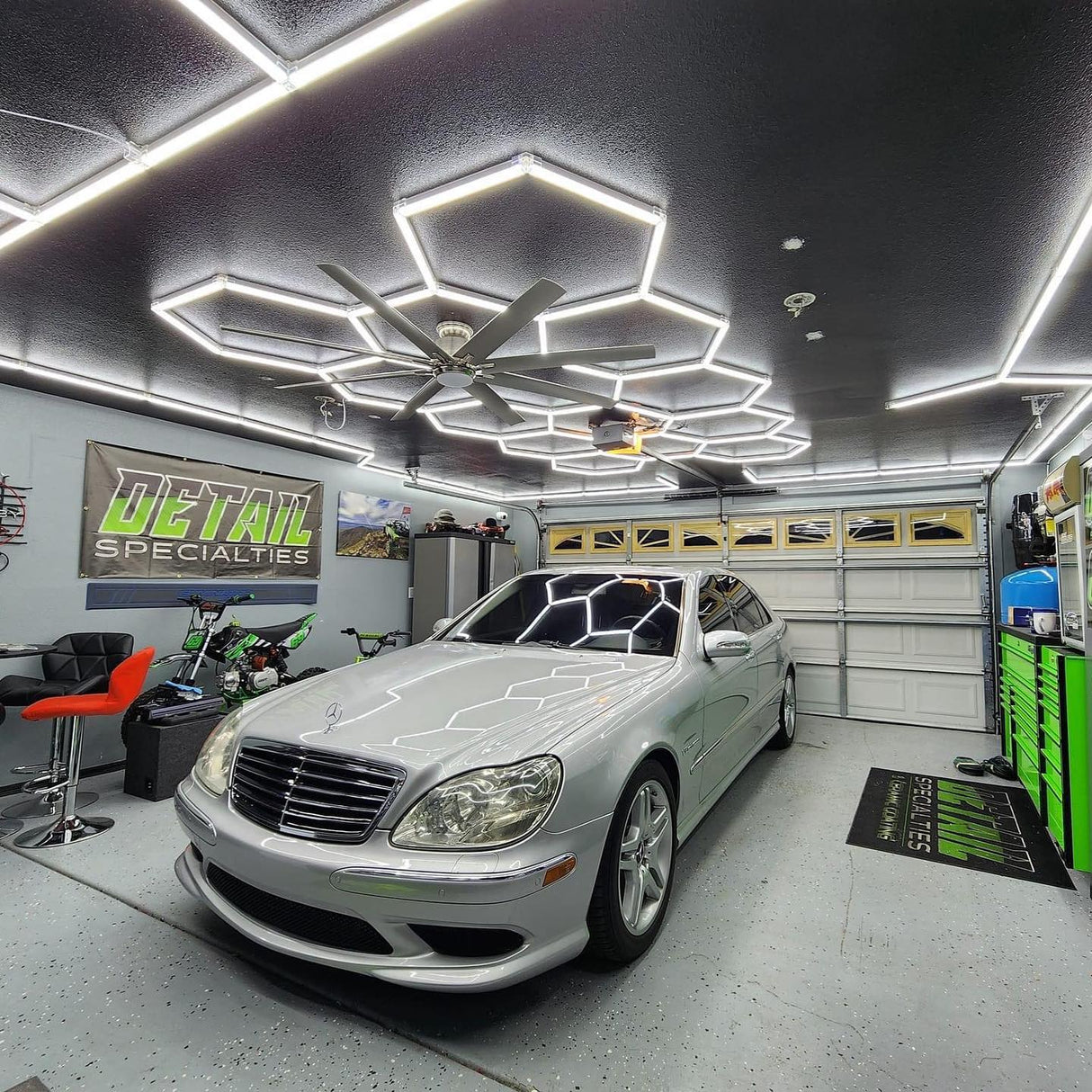 Hexagon garage lights illuminating a silver car