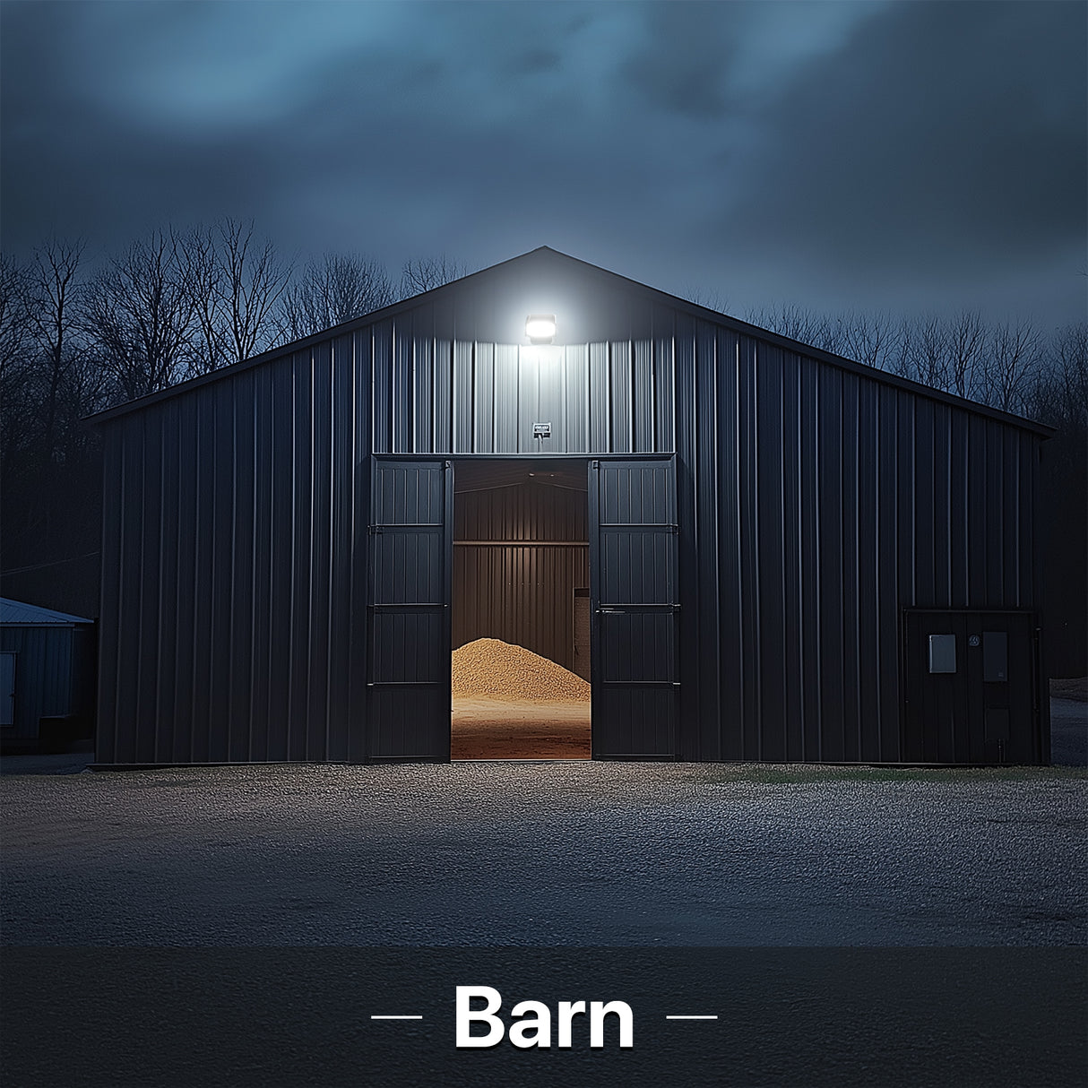 Wall pack light illuminating a barn at night