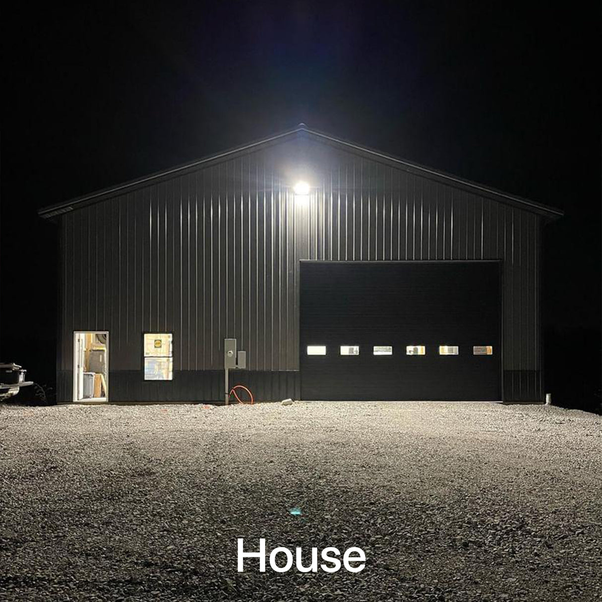 Wall pack light illuminating a house at night