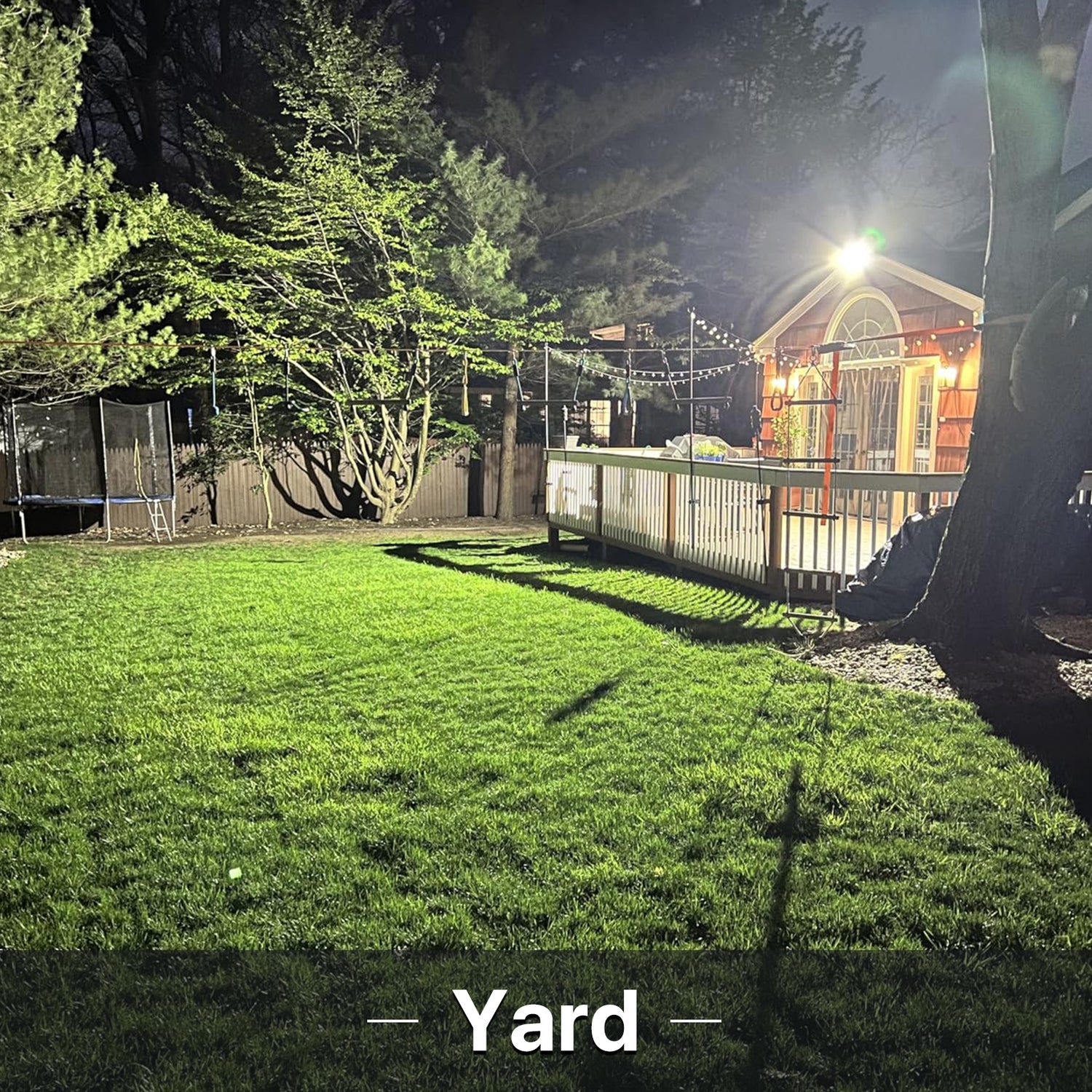 Backyard illuminated by Hyperlite LED flood light at night