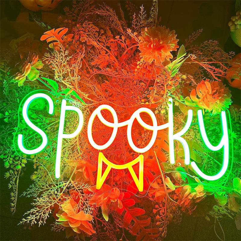 Spooky LED neon sign with decorative foliage