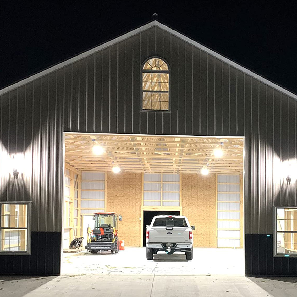 LED high bay lights illuminating a barn interior