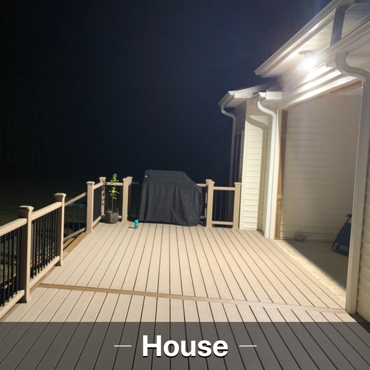 House illuminated by Hyperlite LED flood light at night.