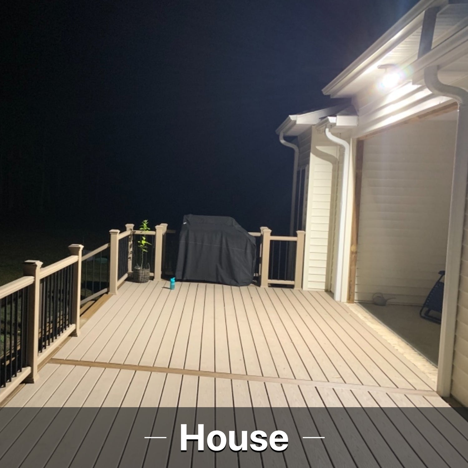 House illuminated by Hyperlite LED flood light at night.