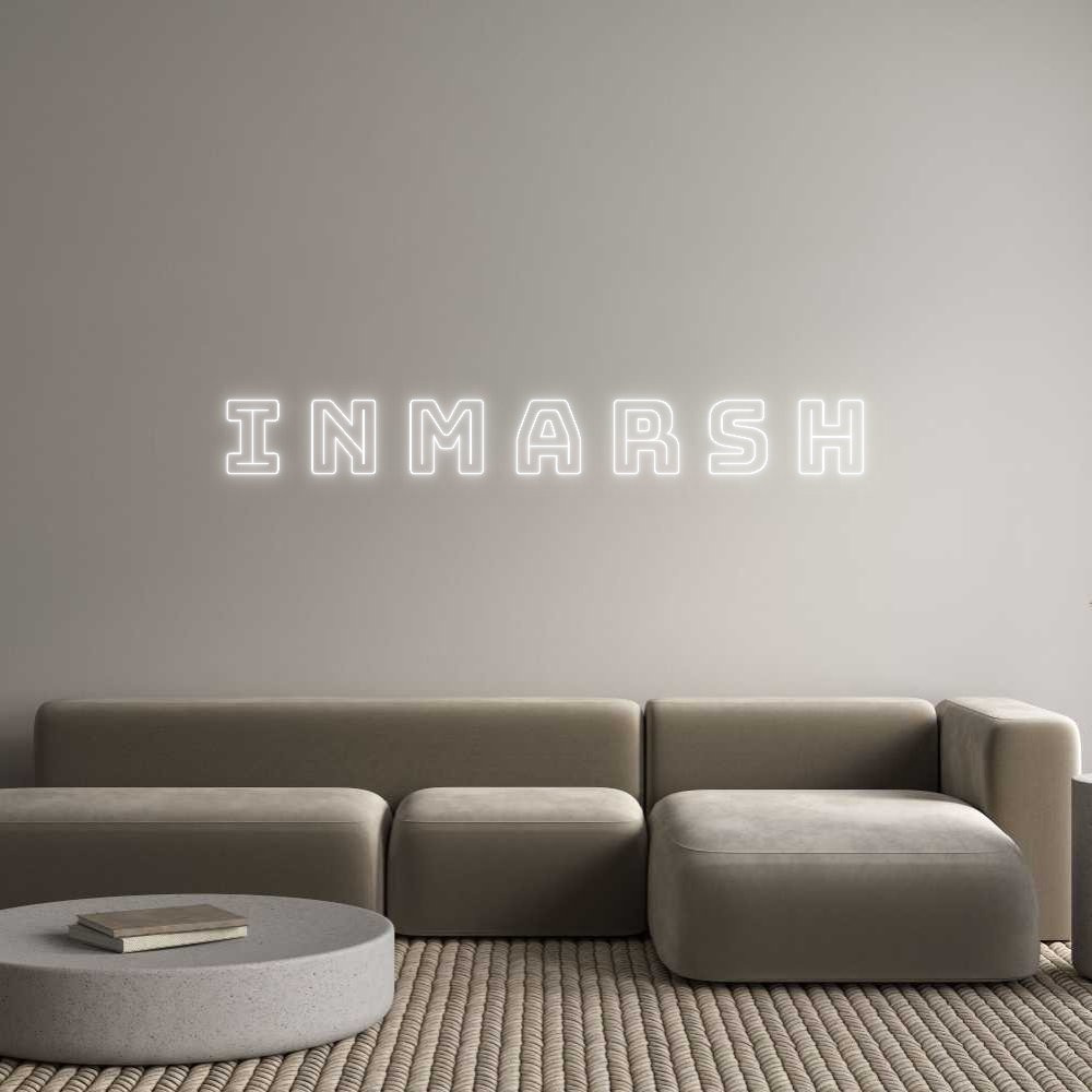 Custom neon light sign 'INMARSH' in white, cut to letter design, mounted on a wall above a modern sofa.