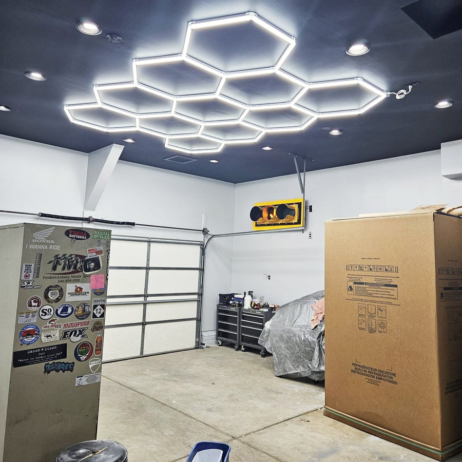 Stylish garage workshop with a custom hex grid LED ceiling lighting system.
