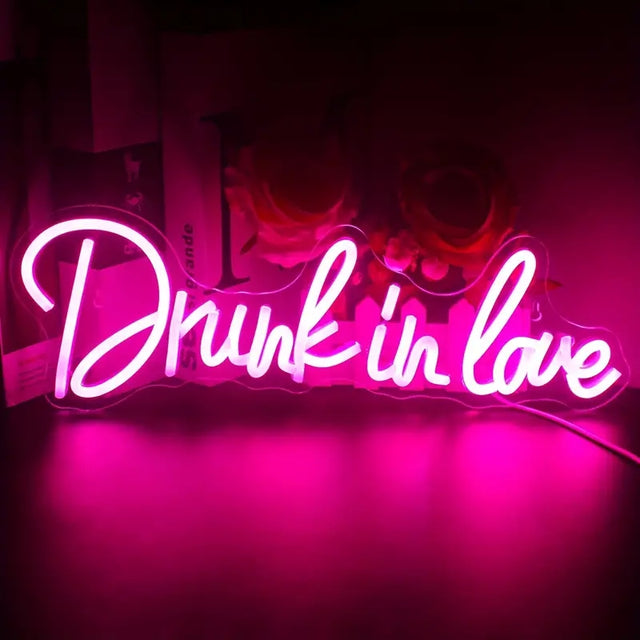 Drunk in Love LED neon sign light glowing in a romantic bedroom setup, perfect for modern wall decor.