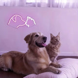 Cute dog and cat face LED neon sign illuminating a veterinary clinic or pet store wall.