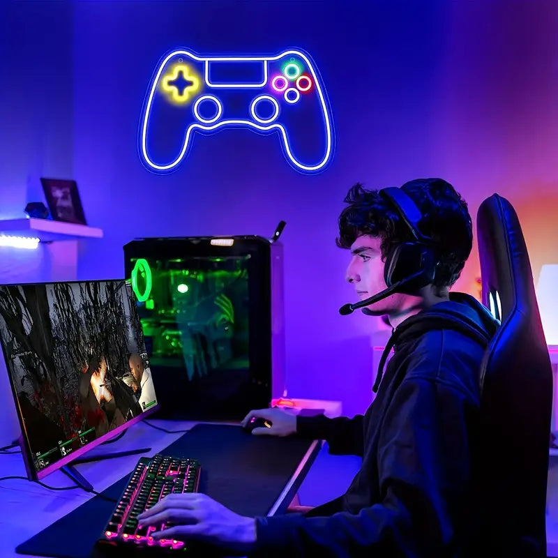Gamer playing under neon game controller sign light