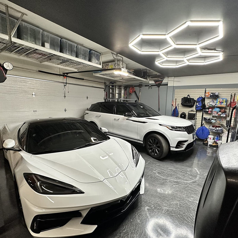 Modern garage with Hyperlite Hexagon lights and luxury cars