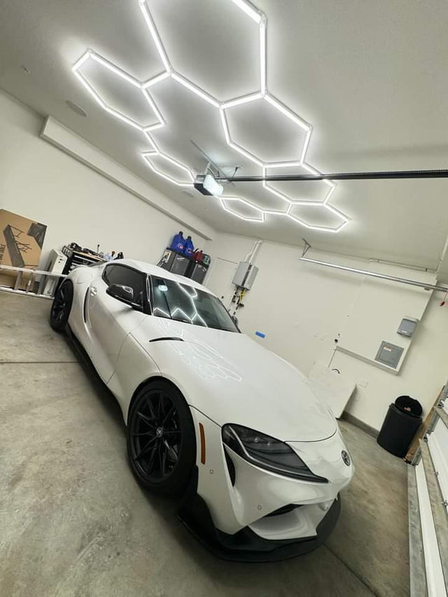 Technicians servicing LED High Bay and LED shop lights in a high-ceiling warehouse