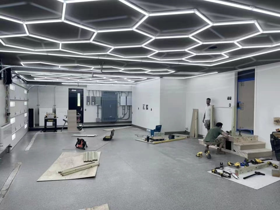 Hexagon LED lights ceiling installation in a garage workshop — bright DIY garage shop lights over workbench