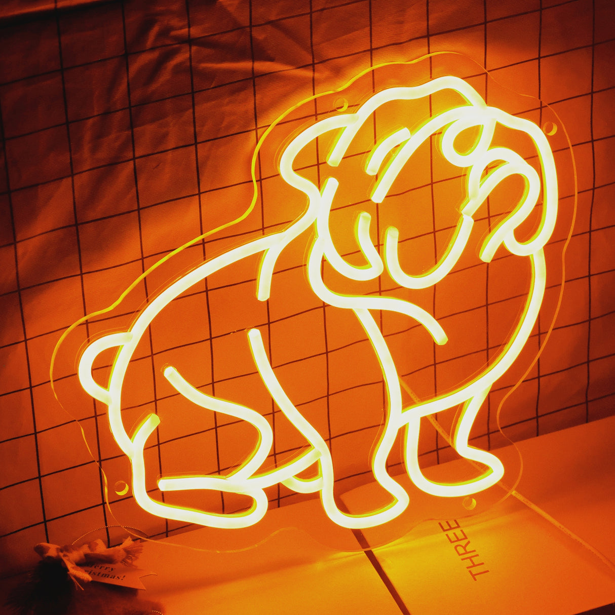 Charming bulldog-shaped neon LED light illuminating a cozy living room wall.