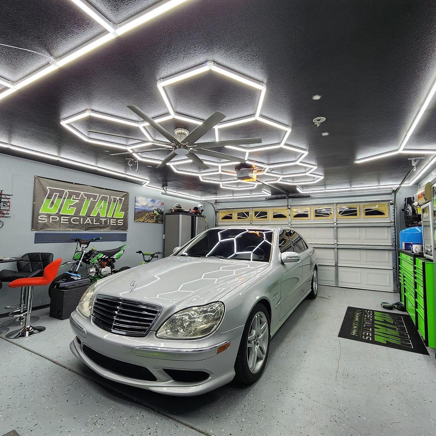 Hexagon garage lights illuminating a silver car