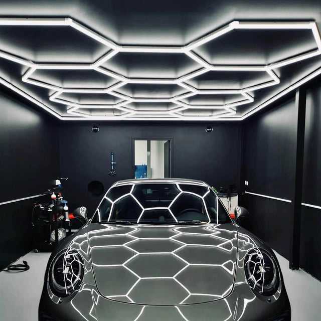 Hexagon LED garage lights illuminating a car