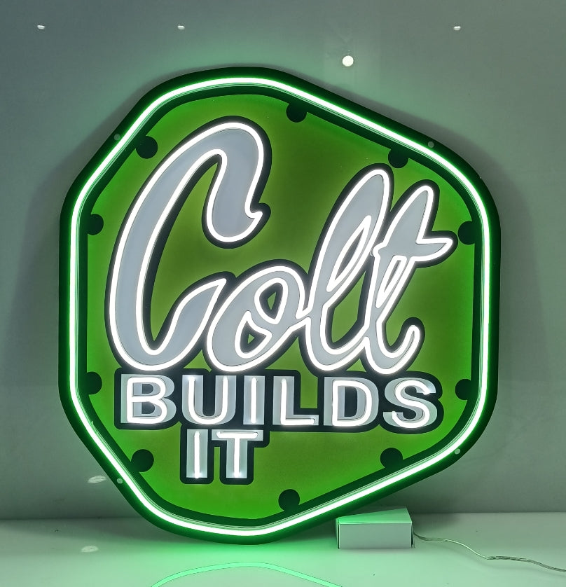 Custom LED neon sign 'Colt BUILDS IT' wall-mounted, green and white illumination for garage/shop décor