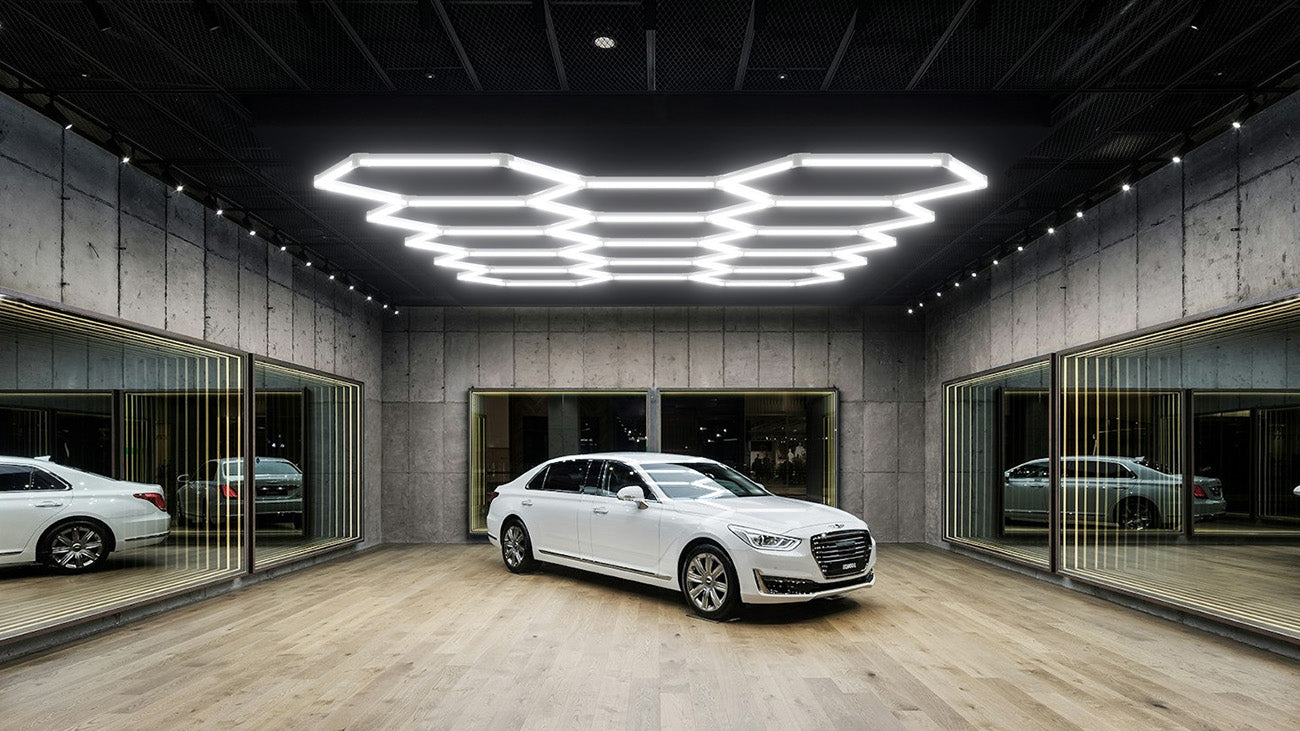 A car parked in garage with hexagon garage lighting.