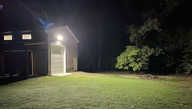 led flood lights lighting up the front of yard of pole barn
