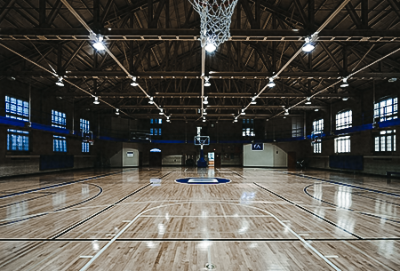 A basketball styled gym with bright commercial lighting.