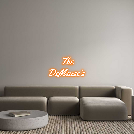 Custom orange neon sign of "The DeMeuse's" in Yellowtail font, wall-mounted above a modern sofa.