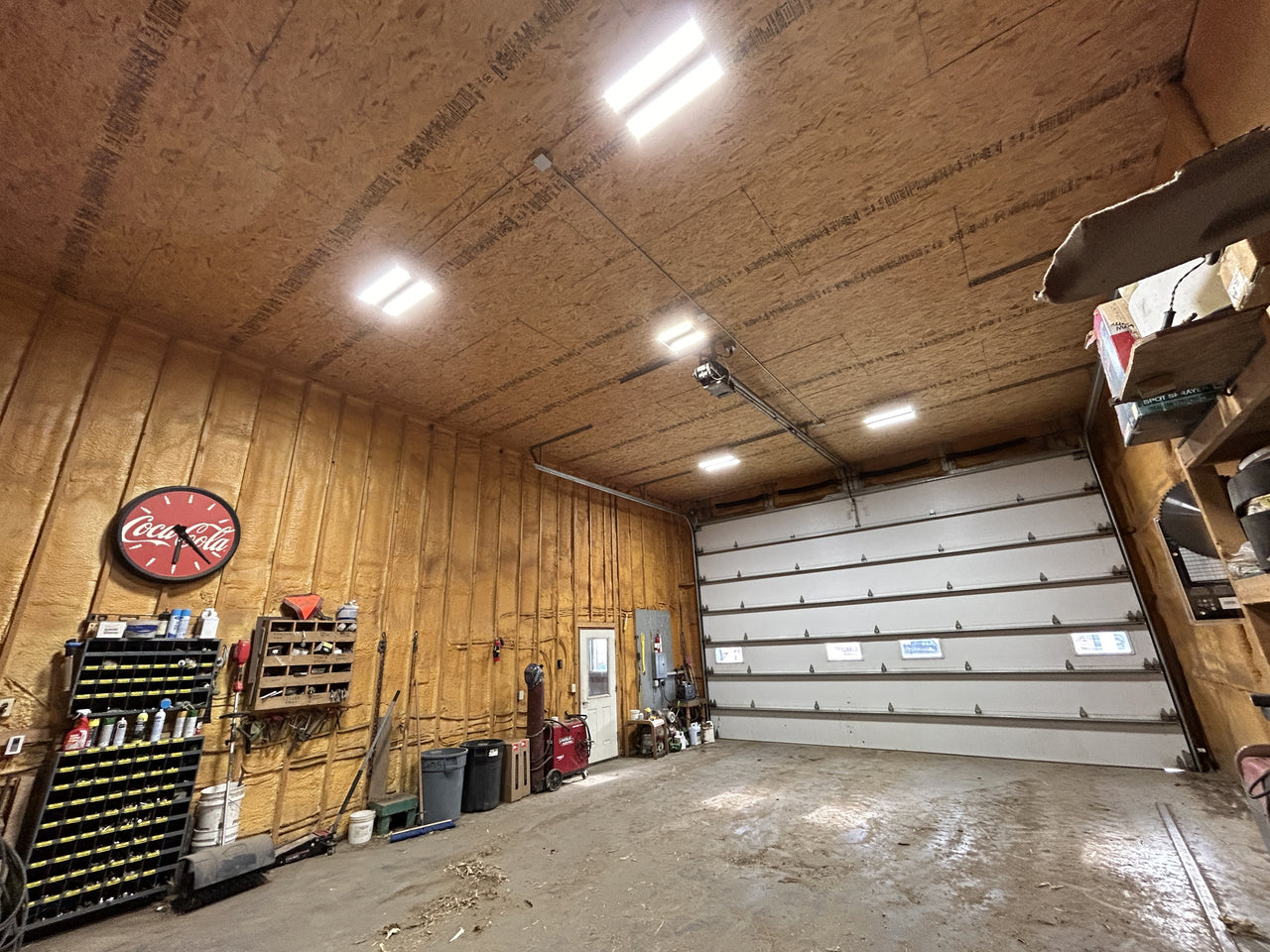 linear high bay lights unsed in a new build workshop with metal shelves and tools